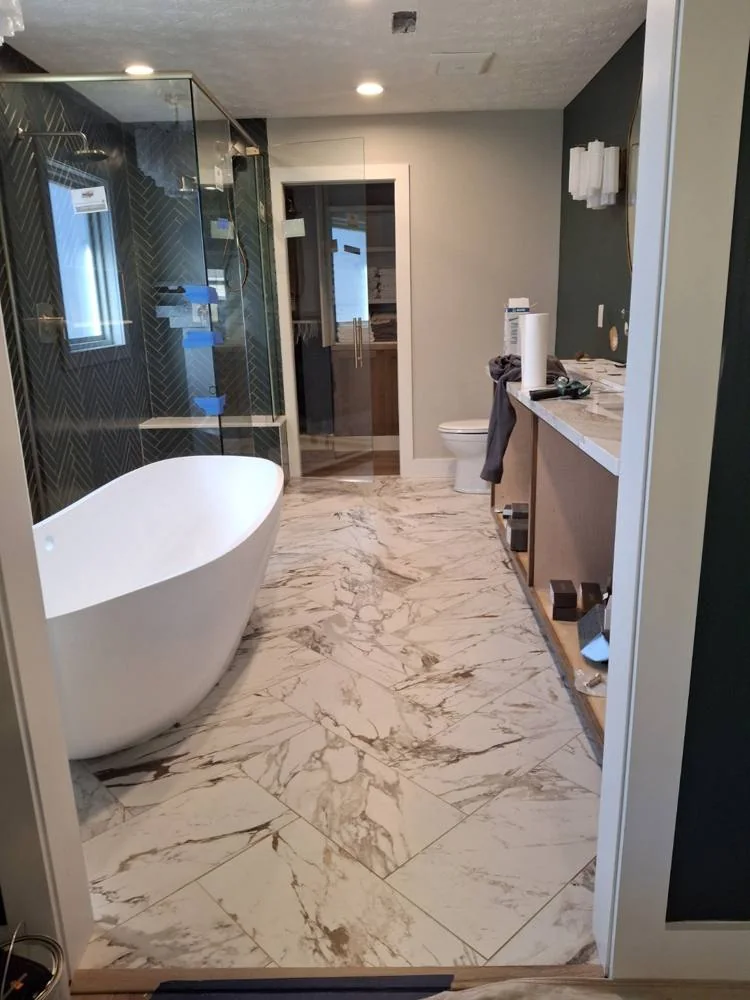 Freestanding bathtub beside a tiled shower